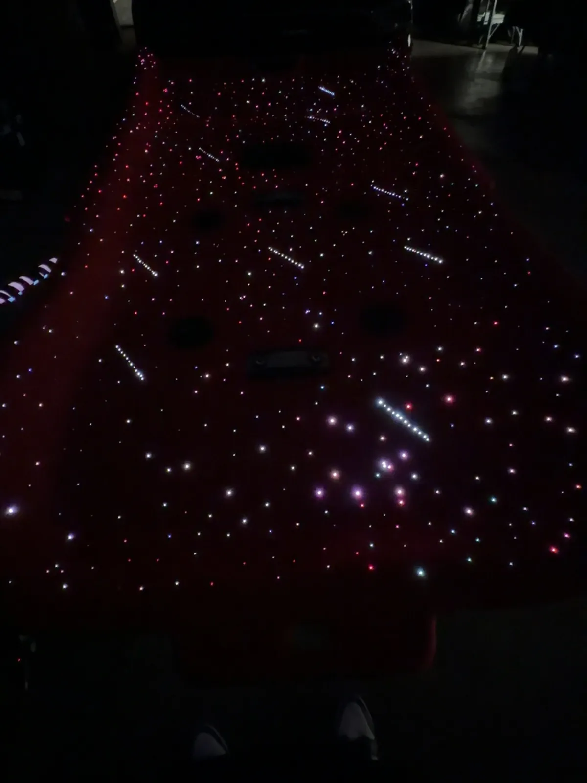 Red suede headliner with fiber-optic stars and shooting stars, lit before installation