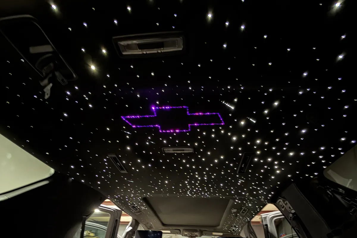 Purple fiber-optic Chevrolet bowtie logo in a starlight headliner