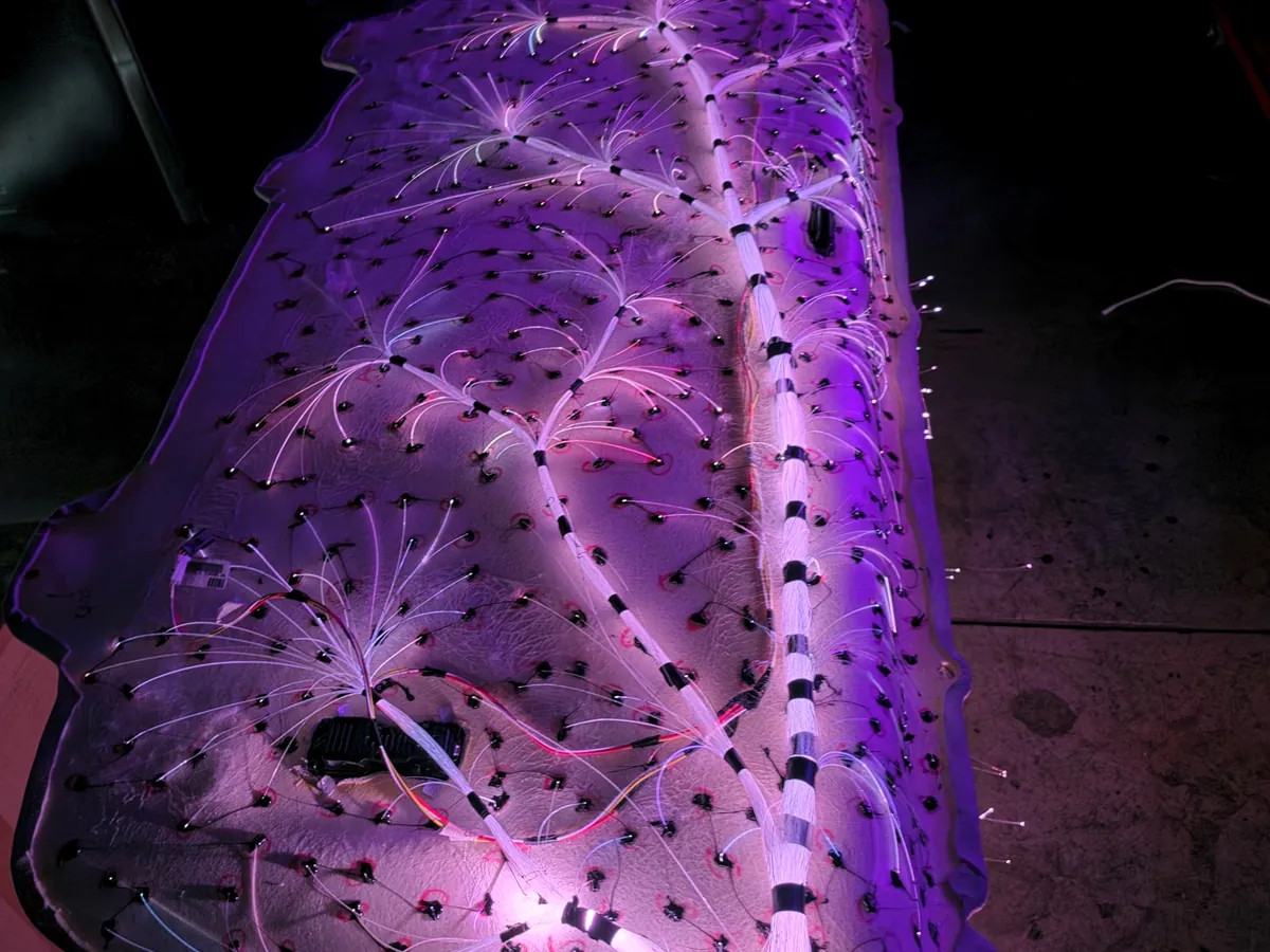 Hundreds of fiber-optic strands routed across the back of a headliner board