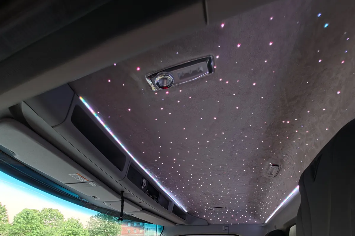 Grey suede starlight headliner with light strips in a Kenworth truck cab
