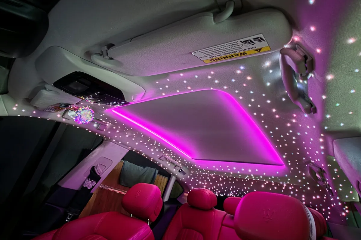 Pink sunroof ambient strip surrounded by fiber-optic stars