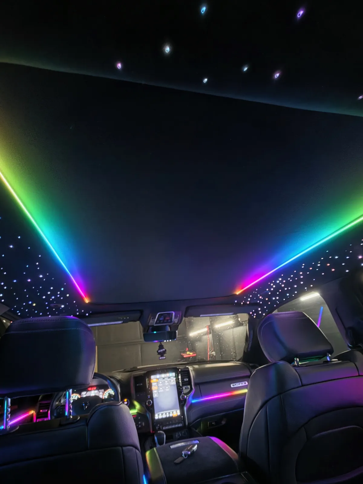 Rainbow Dream Color light lines across a starlight headliner in a Ram pickup